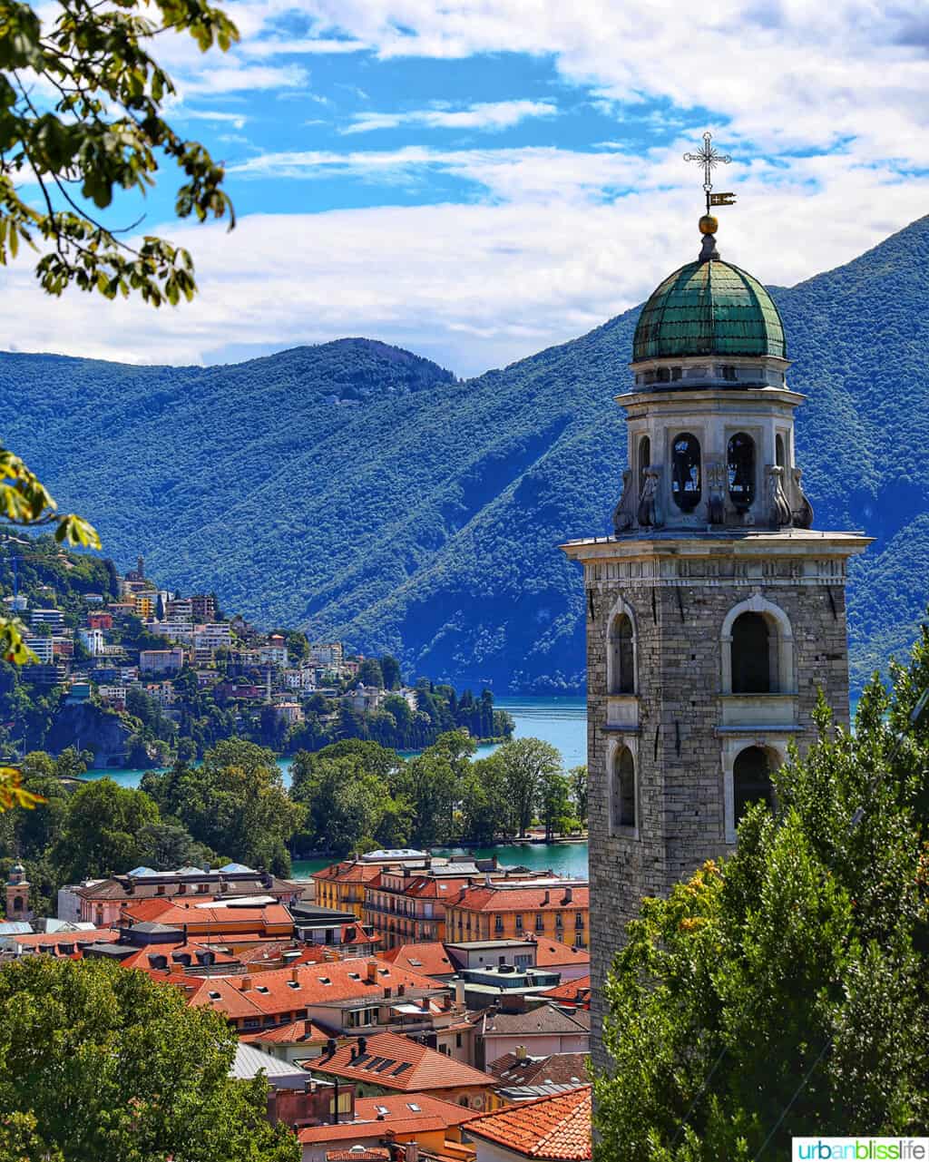 church steeple, clay rooftops, and mountains of Lugano, Switzerland