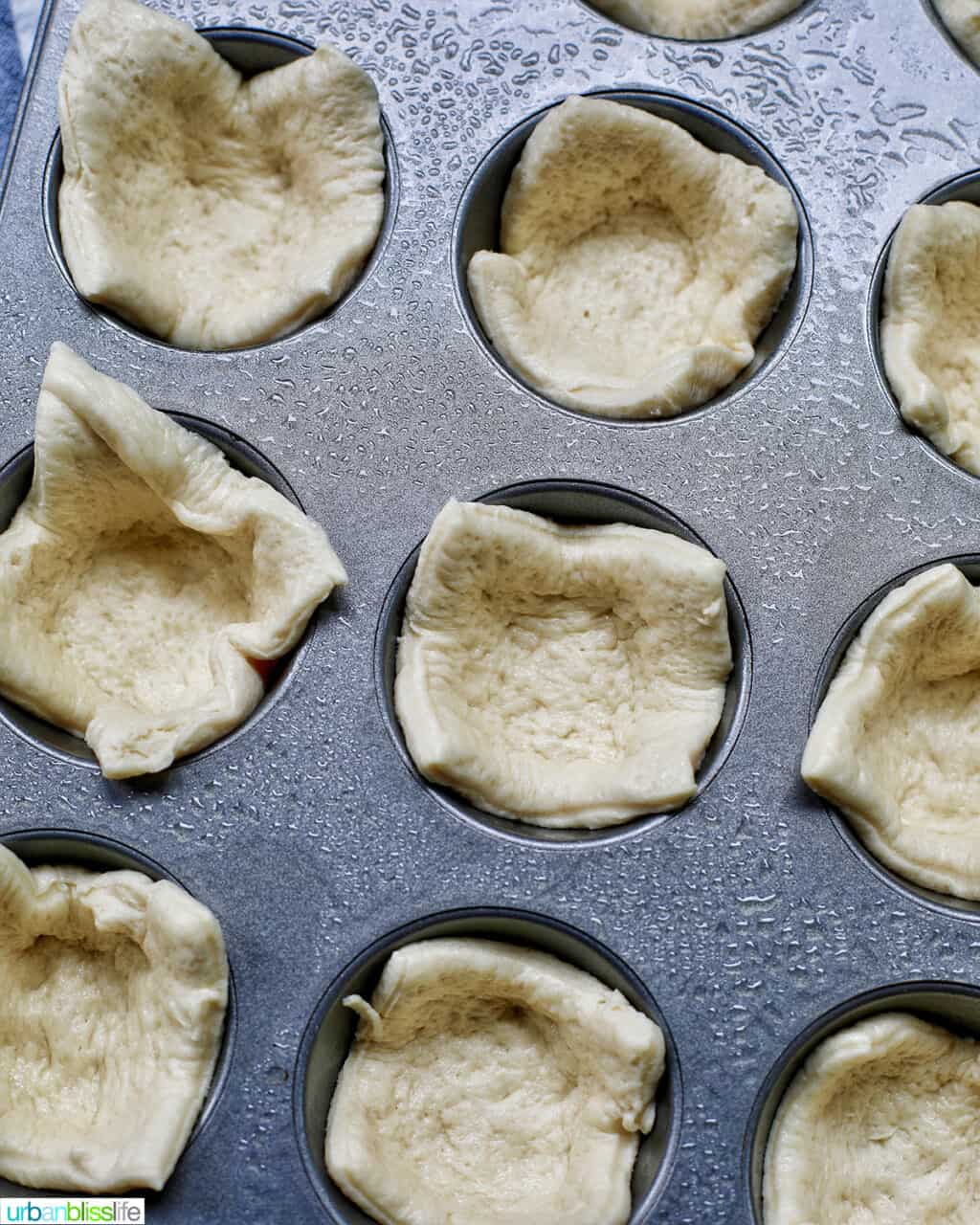 pizza crust dough in muffin tins