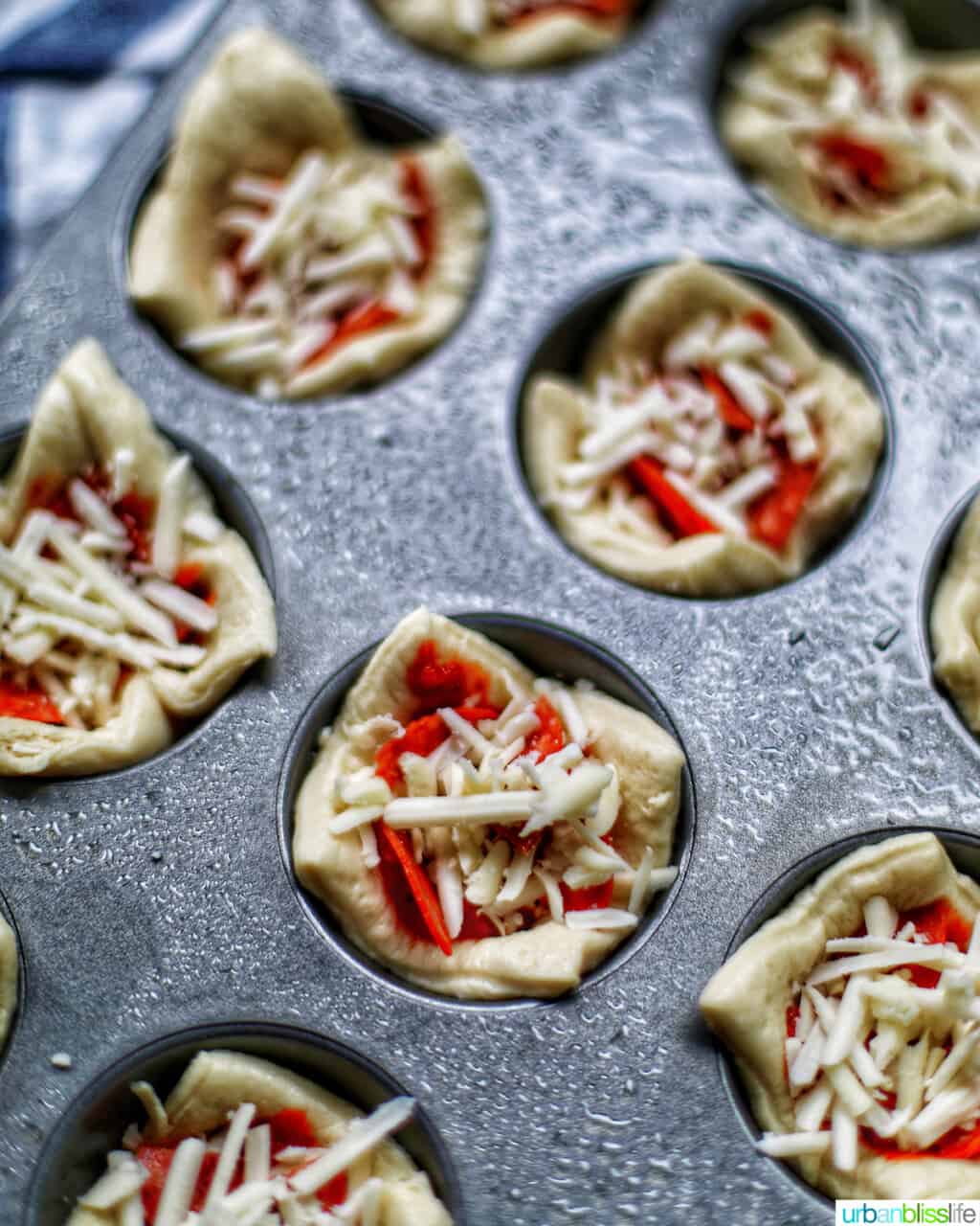 pizza cups in muffin tins ready to go into the oven