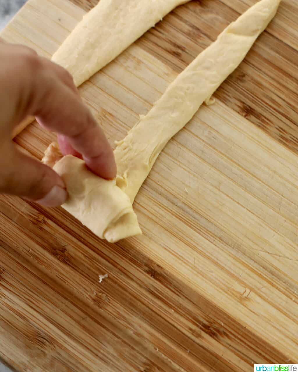 rolling mozzarella cheese inside dough