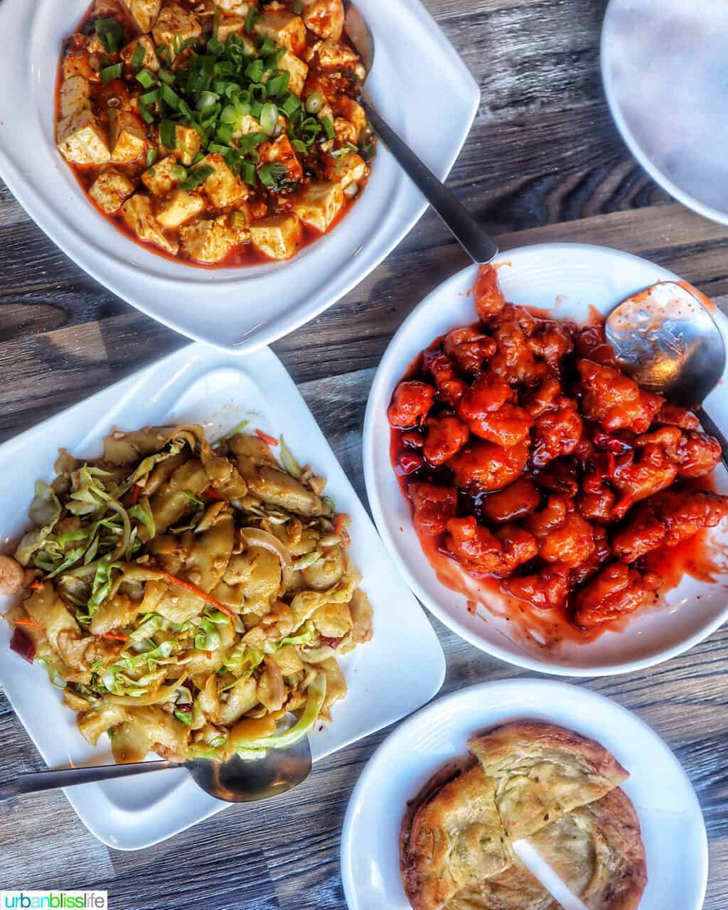 four plates with Chinese food at Tasty Corner restaurant in Portland Oregon.