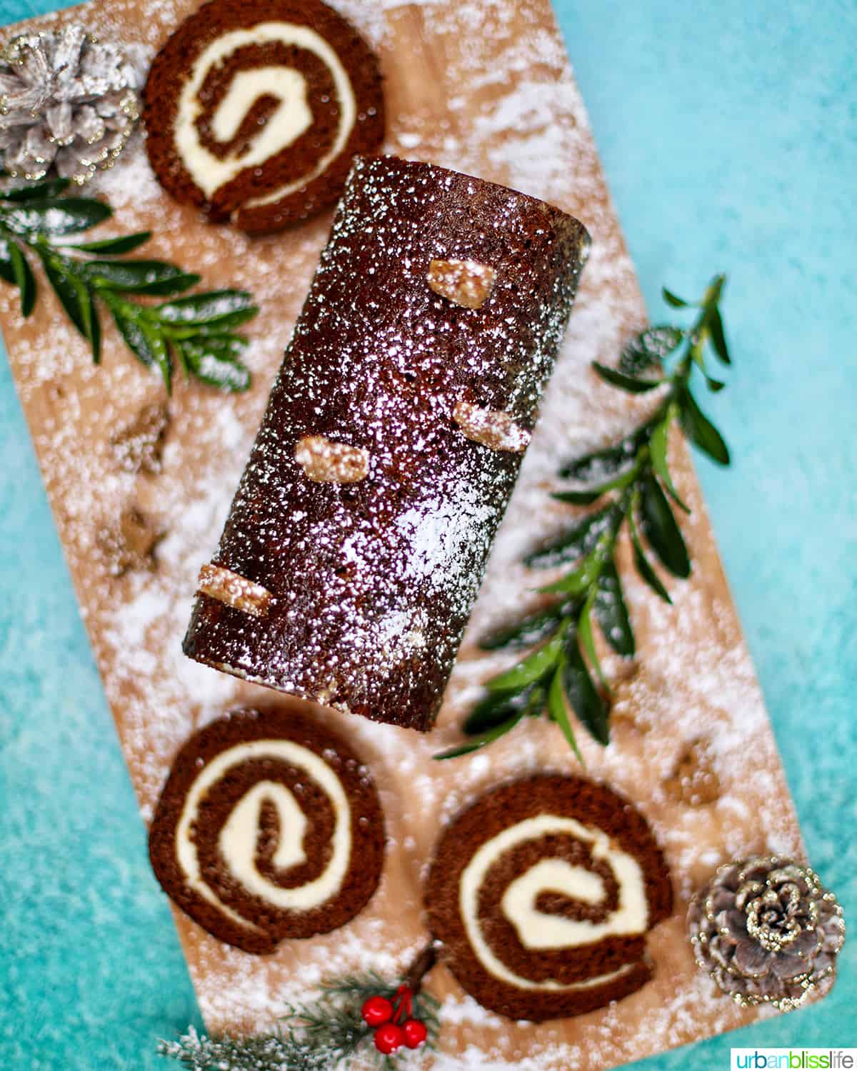 Gingerbread cake roll with holiday trimmings, cream cheese filling, and Christmas decorations.