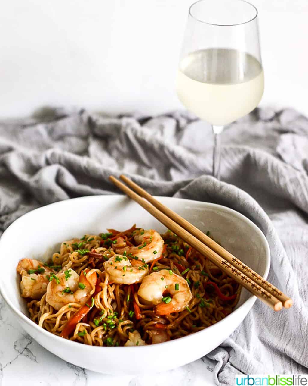 shrimp lo mein with glass of white wine