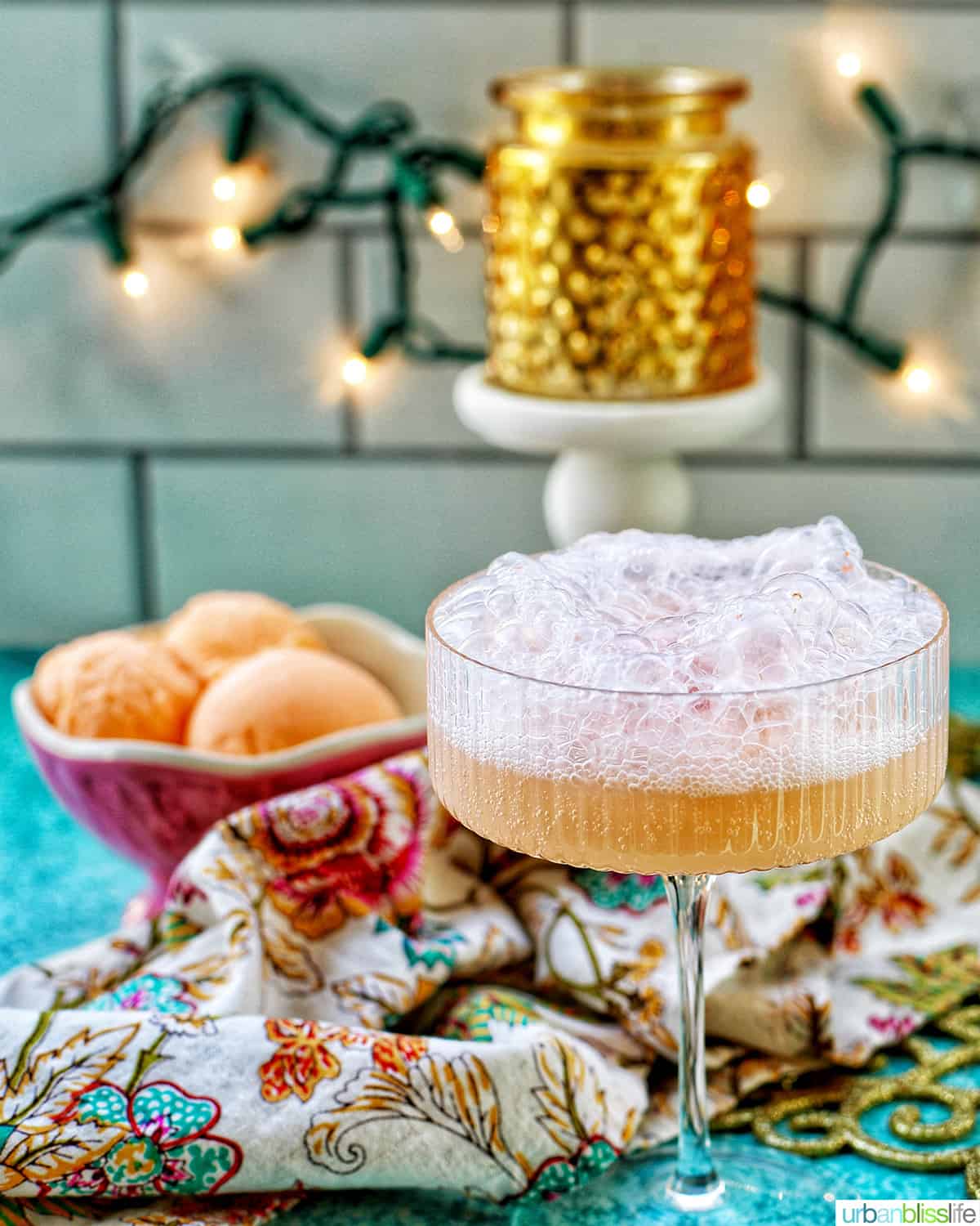 champagne floats with bowl of sherbet and twinkling lights in the background.