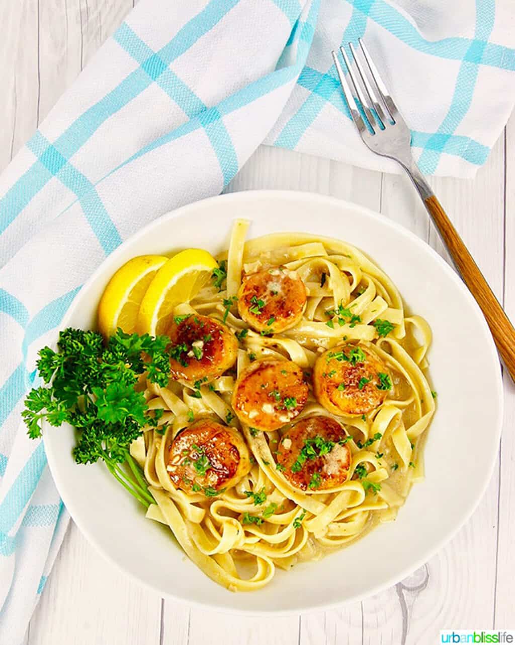 Seared scallops with pasta in a bowl