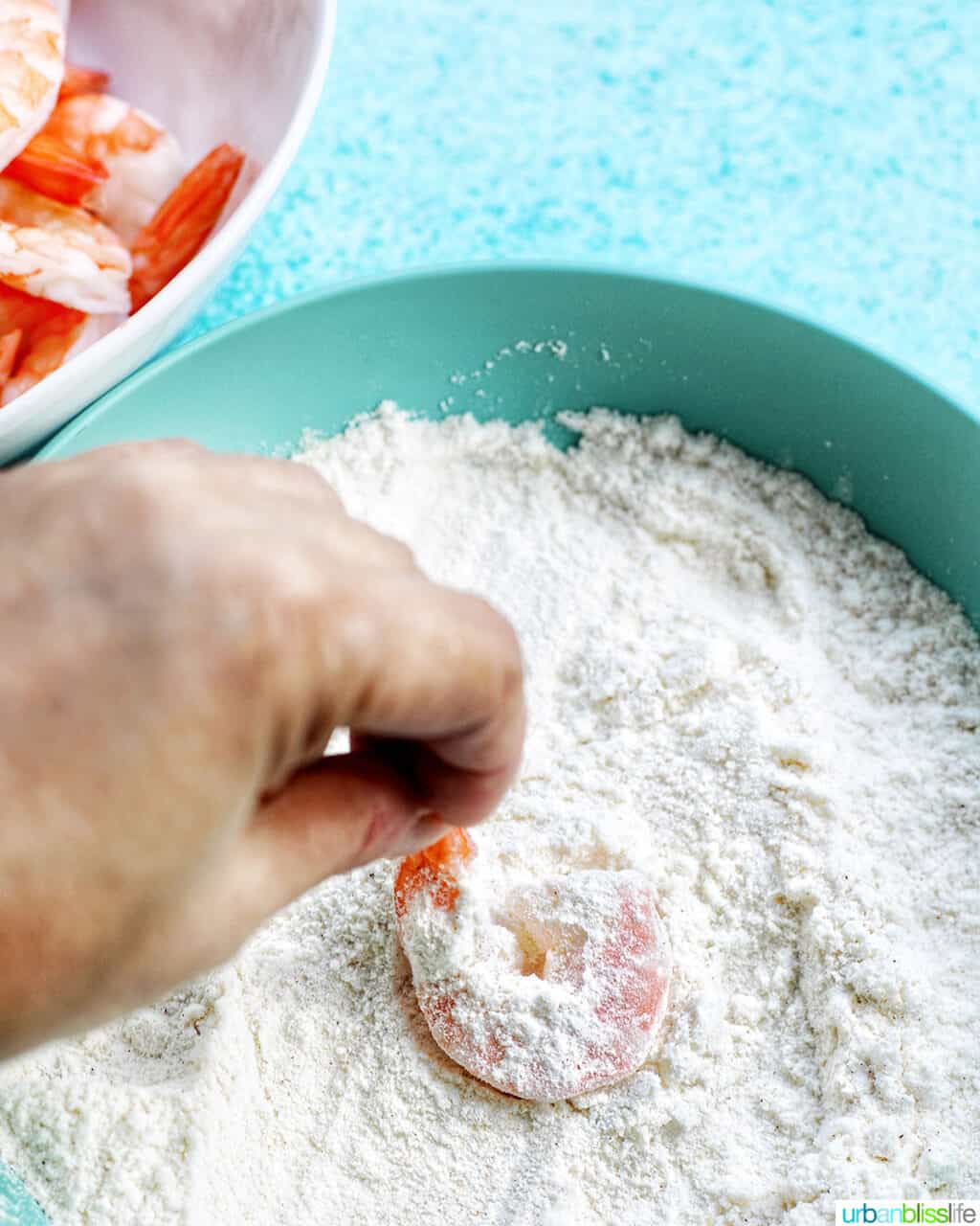 dredging shrimp in flour mixture