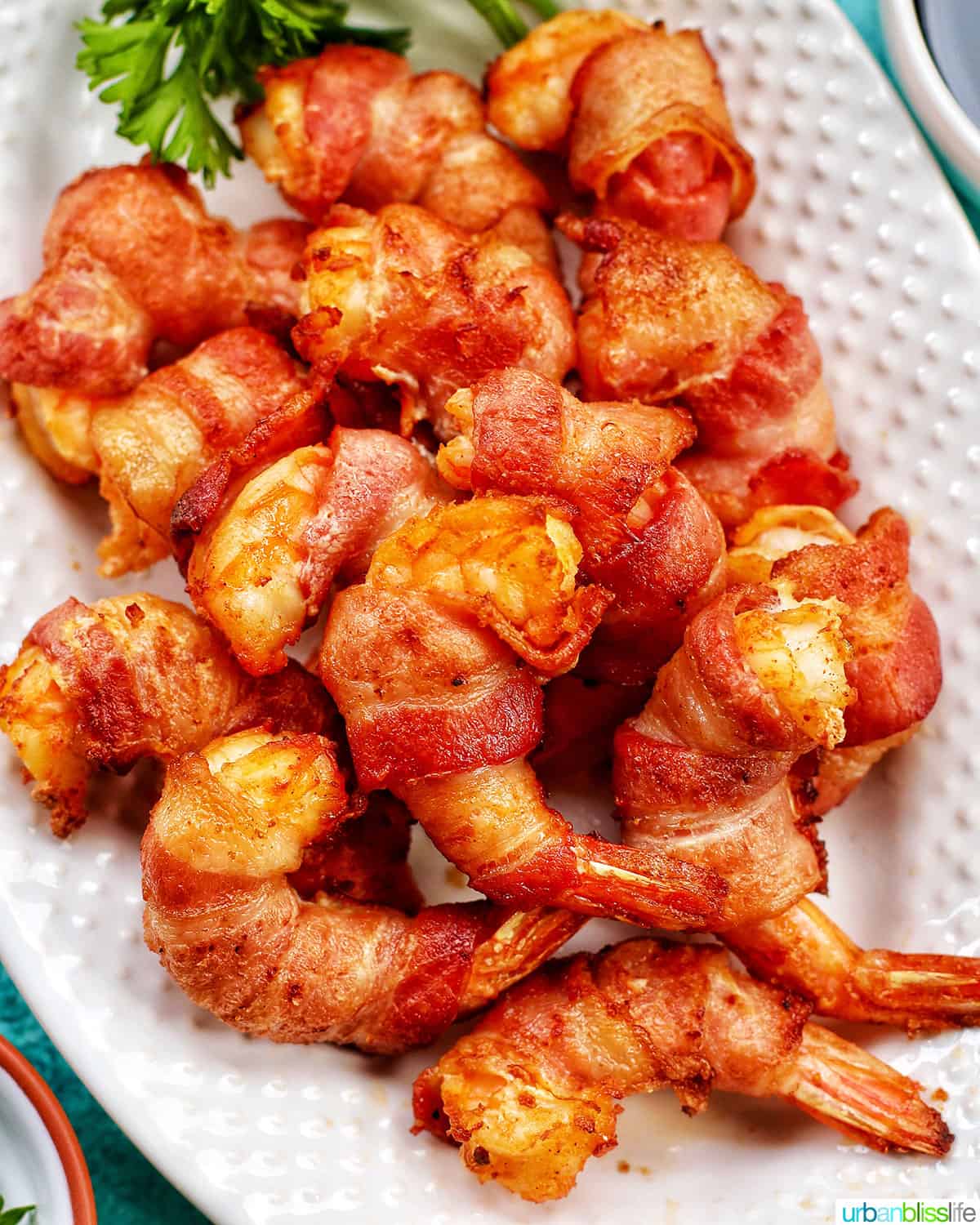 air fryer bacon wrapped shrimp on a plate FEATURE