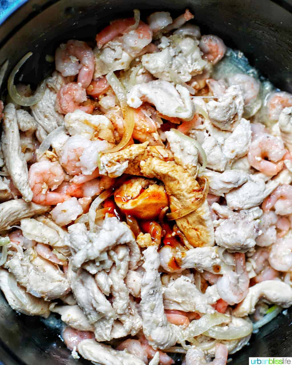 adding Filipino sauce to adding shrimp to Filipino pancit canton noodles