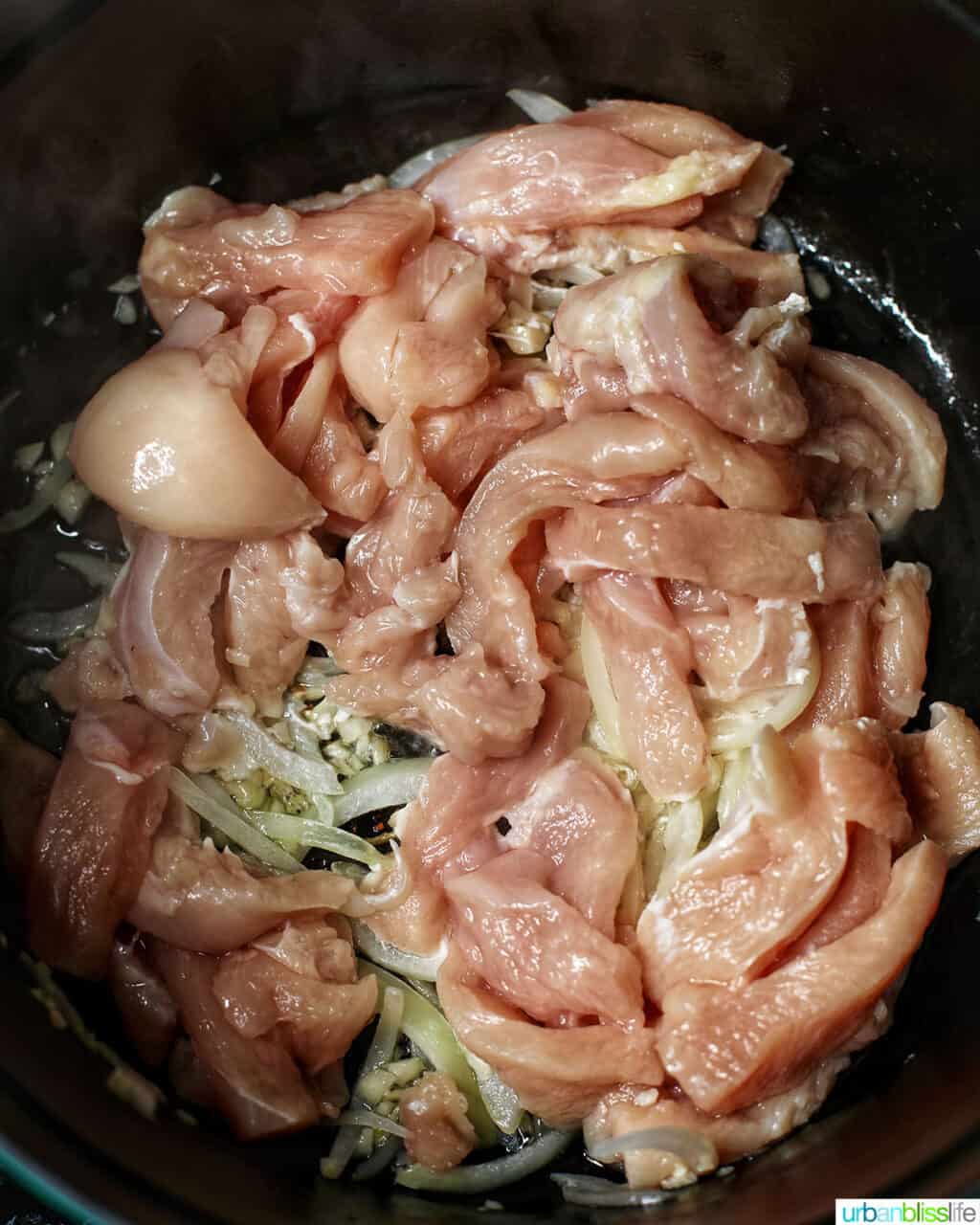 adding chicken to adding shrimp to Filipino pancit canton noodles