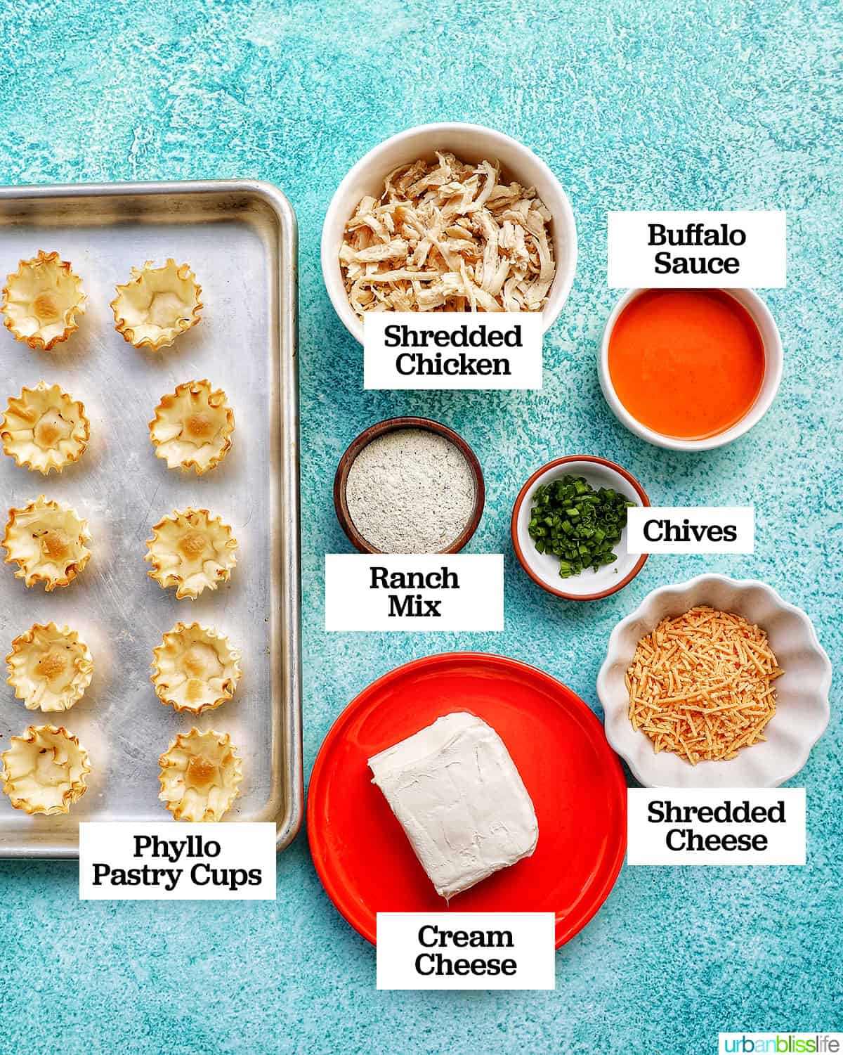 bowls of ingredients to make buffalo chicken bites on bright blue background.