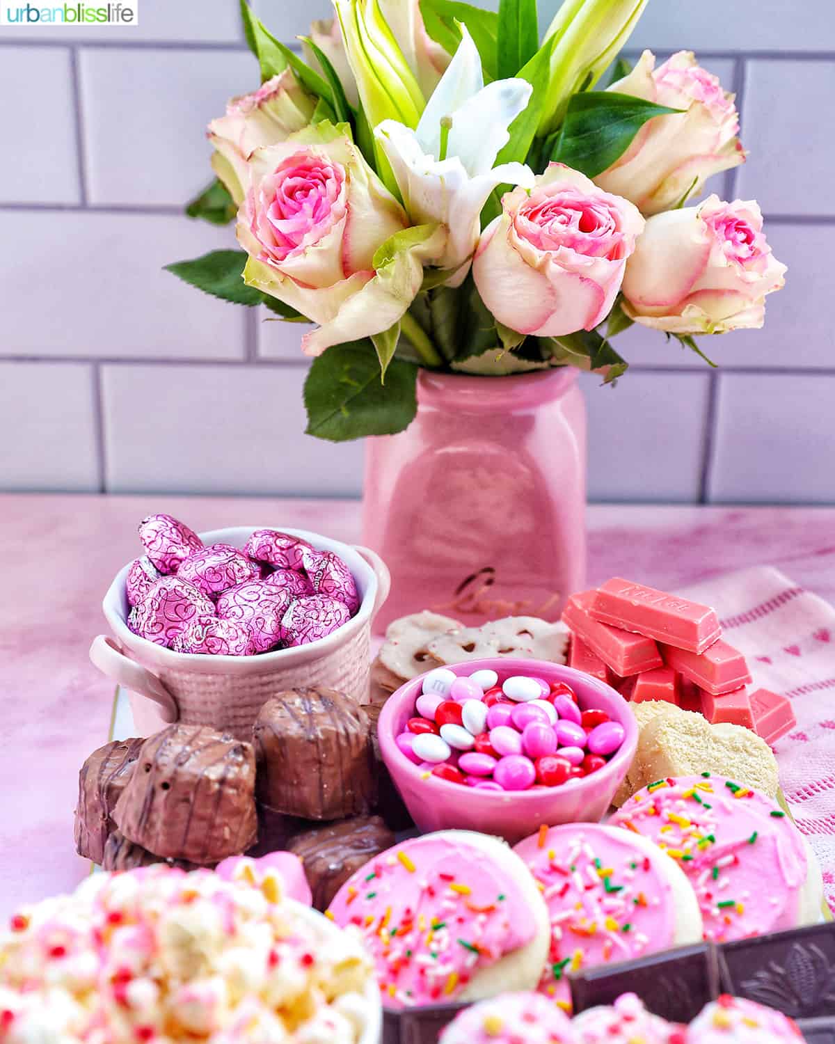 roses in a vase with a Valentine's Day Dessert Charcuterie Board