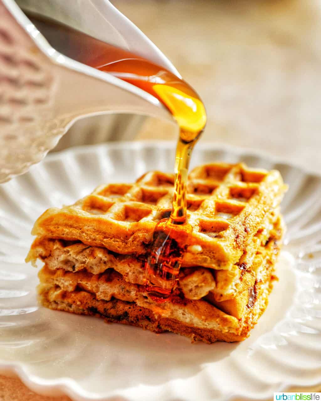 https://urbanblisslife.com/wp-content/uploads/2022/01/banana-chocolate-chip-waffles-pour-syrup-1024x1280.jpg