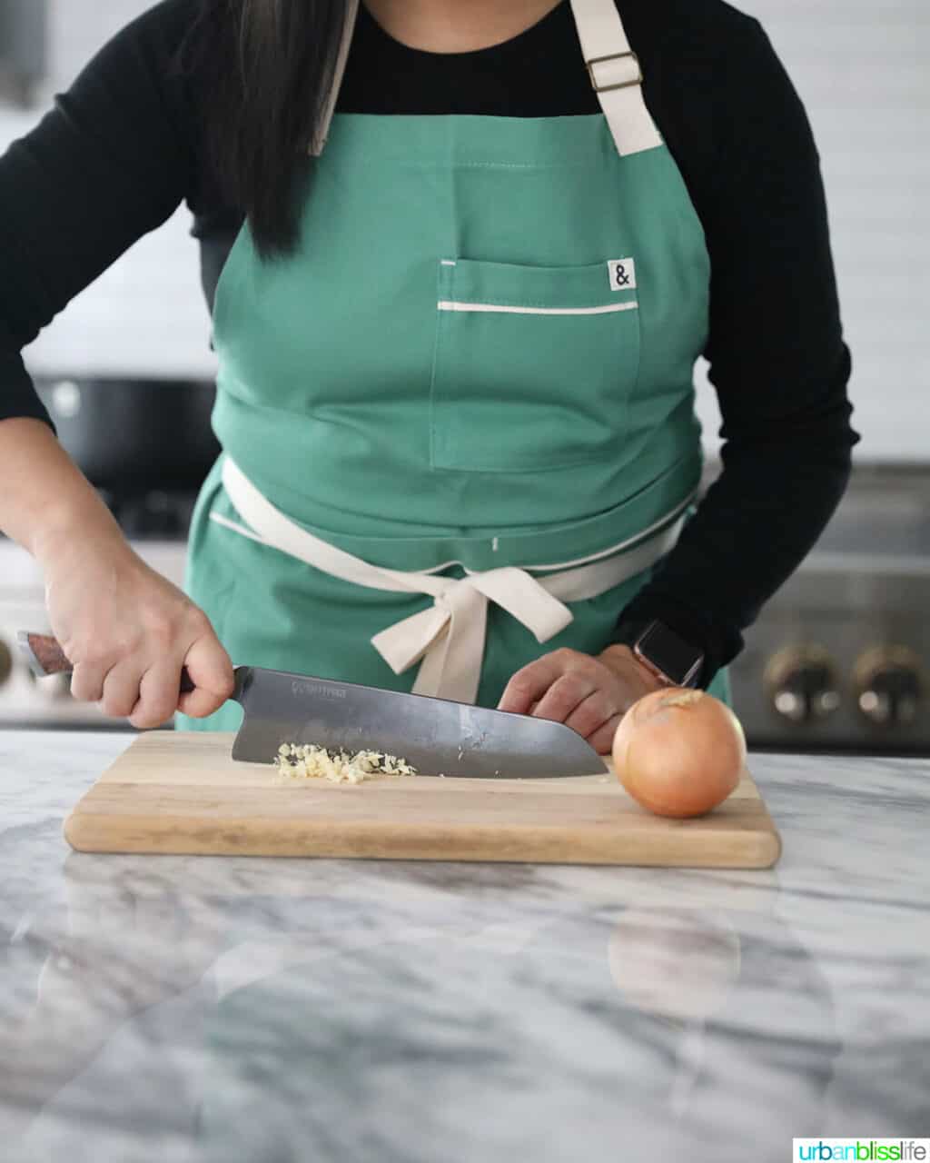 chopping garlic and onions with a high carbon steel chefs knife