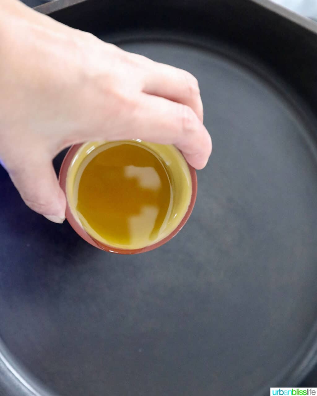 adding olive oil to pan
