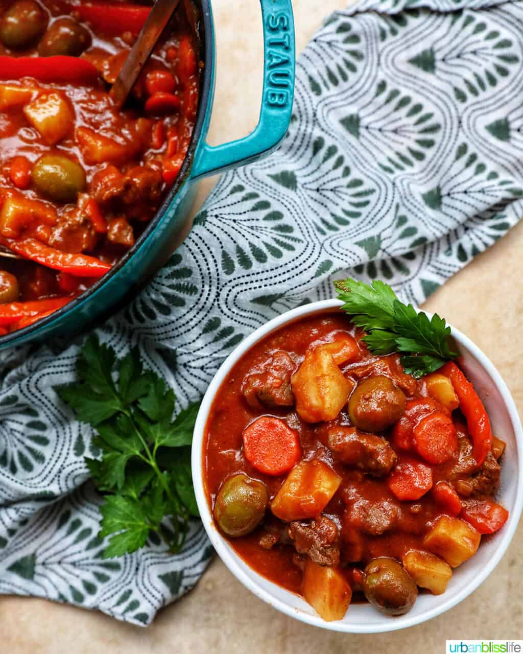 bowl and large pot of of beef caldereta