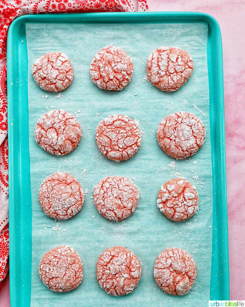 strawberry crinkle cookies baked on baking sheet