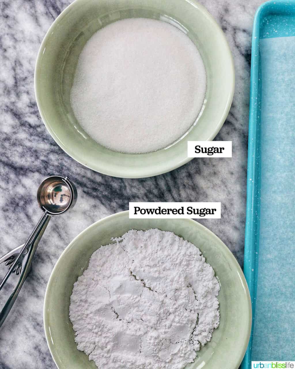 bowls of granulated sugar and powdered sugar for cookies.