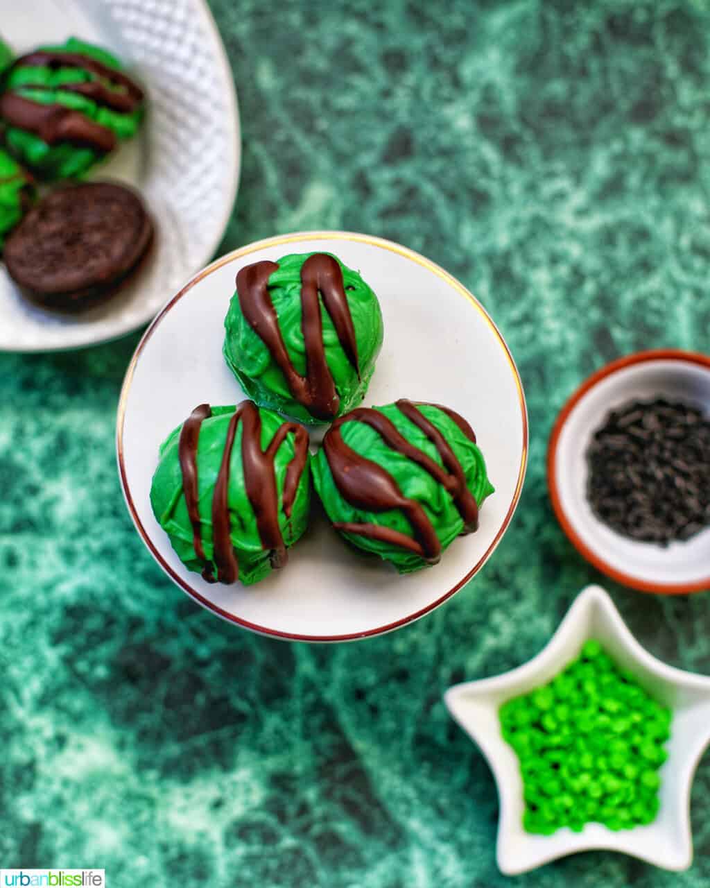 mint oreo truffles on a plate with sprinkles on the side