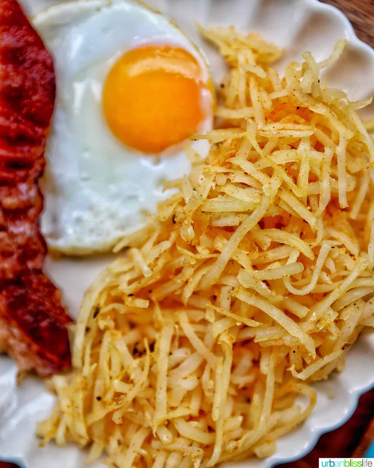 shredded air fryer hash browns with bacon and eggs