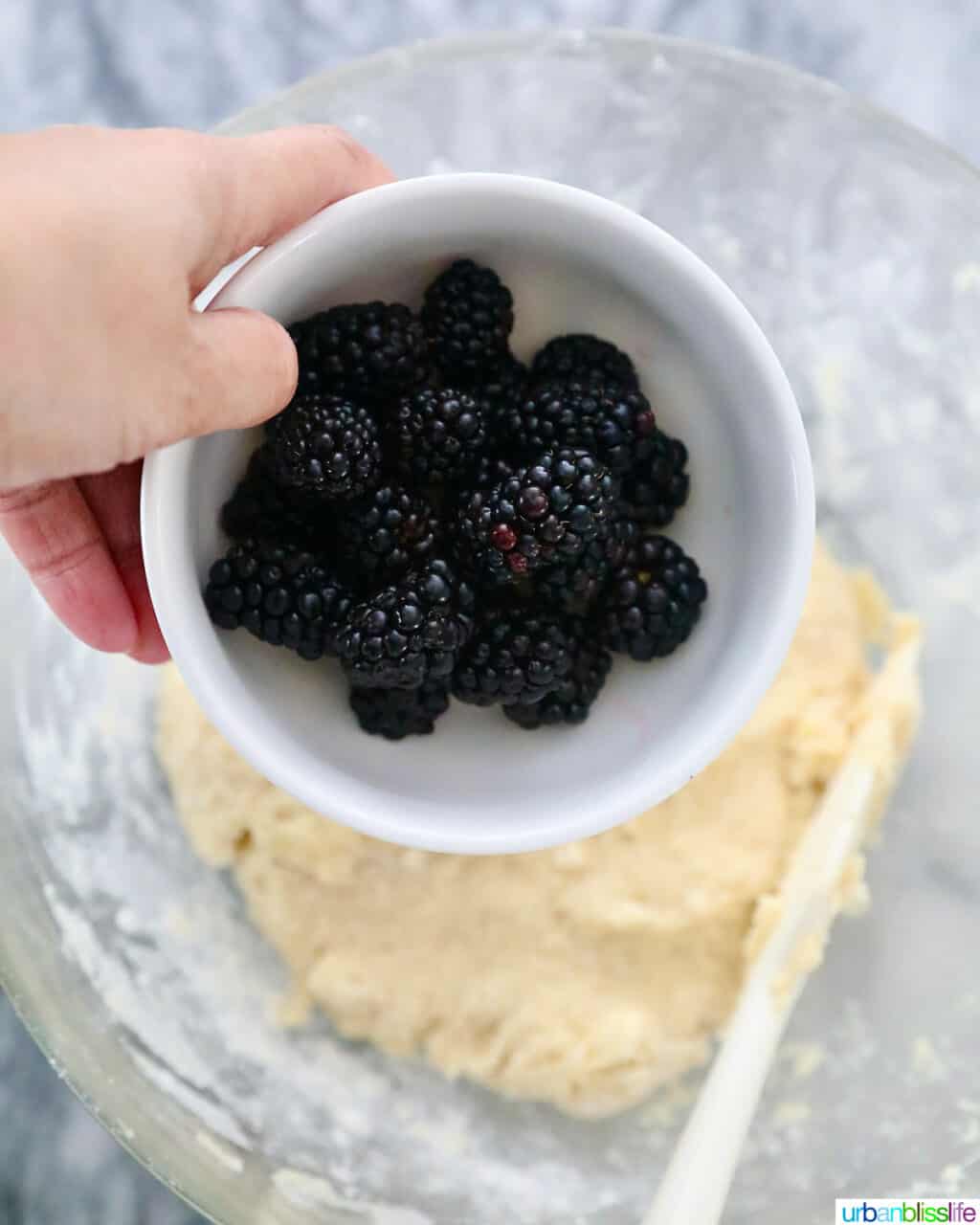 adding blackberries to scones