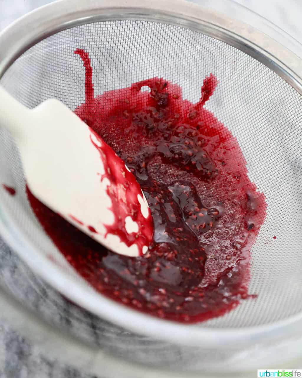 straining blackberries