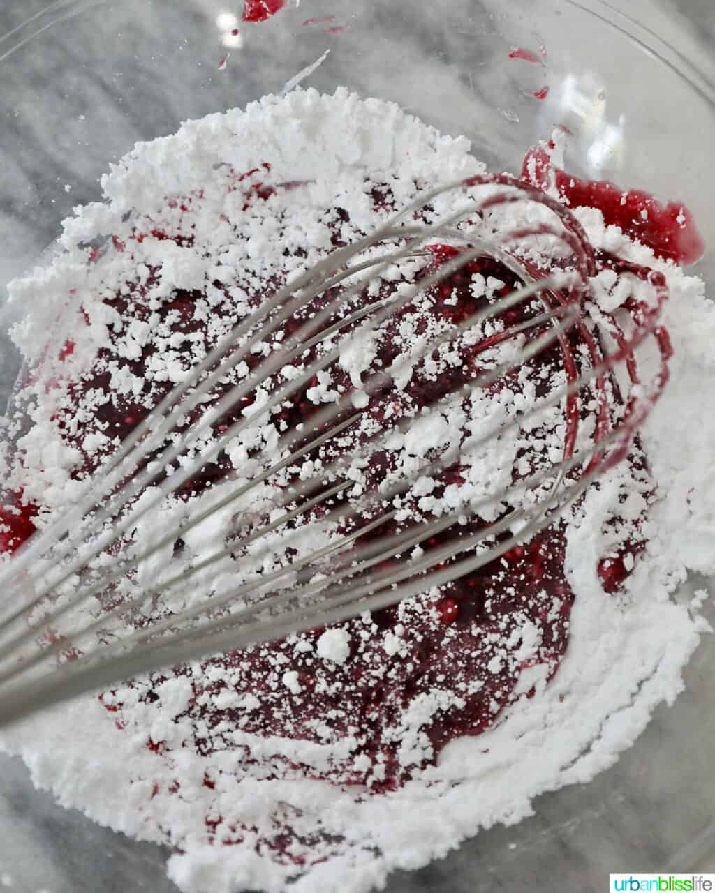 adding powdered sugar to blackberries to make a glaze