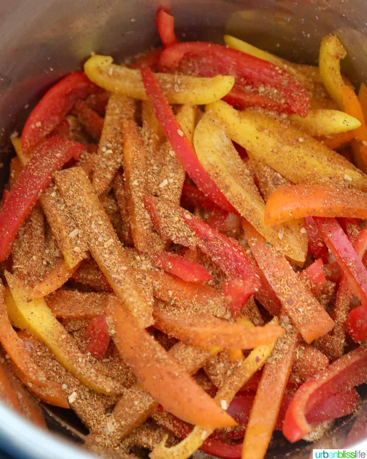 adding spices to peppers for chicken fajitas