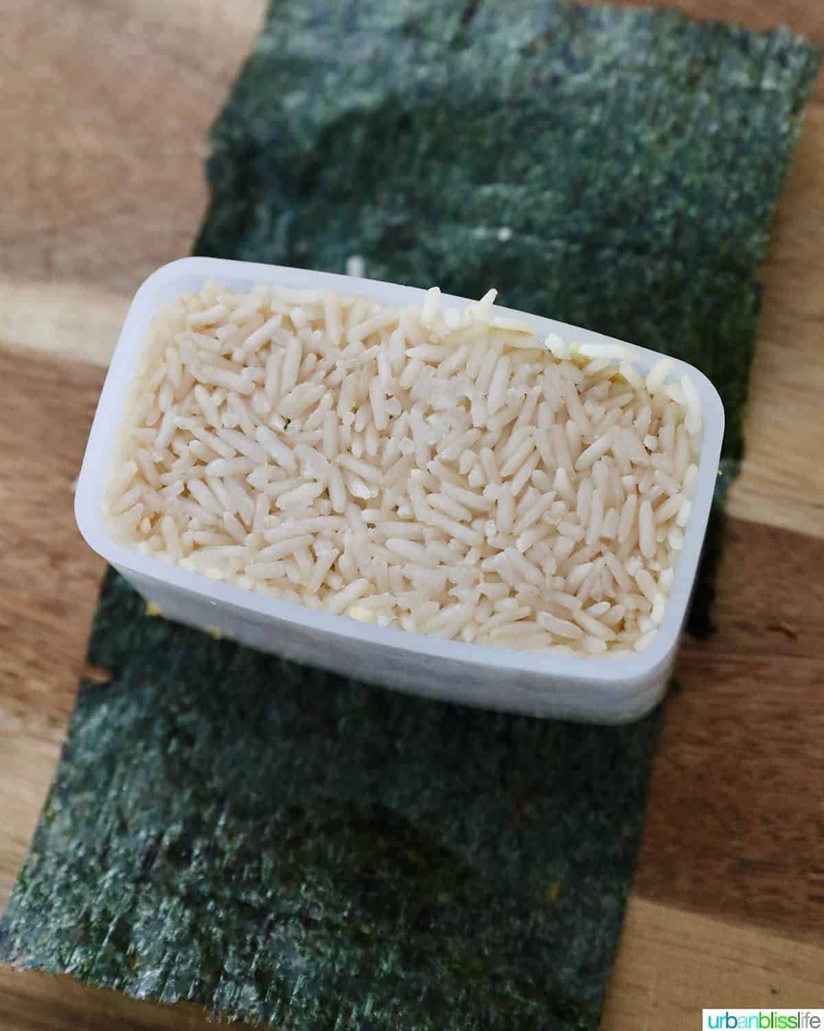 rice in the musubi mold over nori seaweed sheet