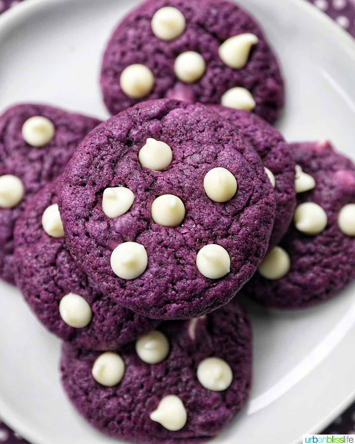 bright purple Ube cookies with white chocolate chips on a white plate.