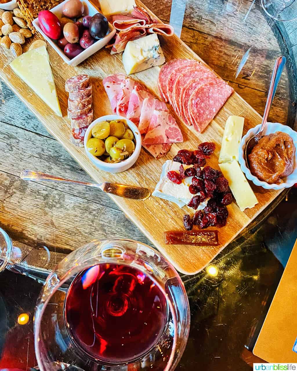 cheese and charcuterie board, and glass of Pinot Noir, at Fullerton Wine Bar