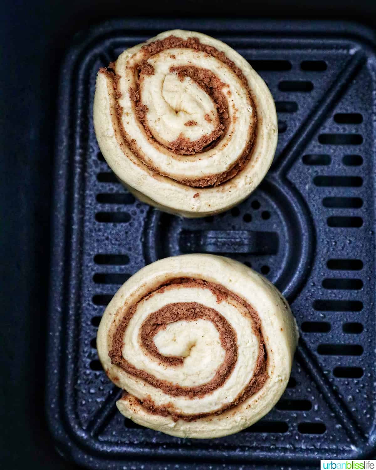 two cinnamon rolls ready to air fry