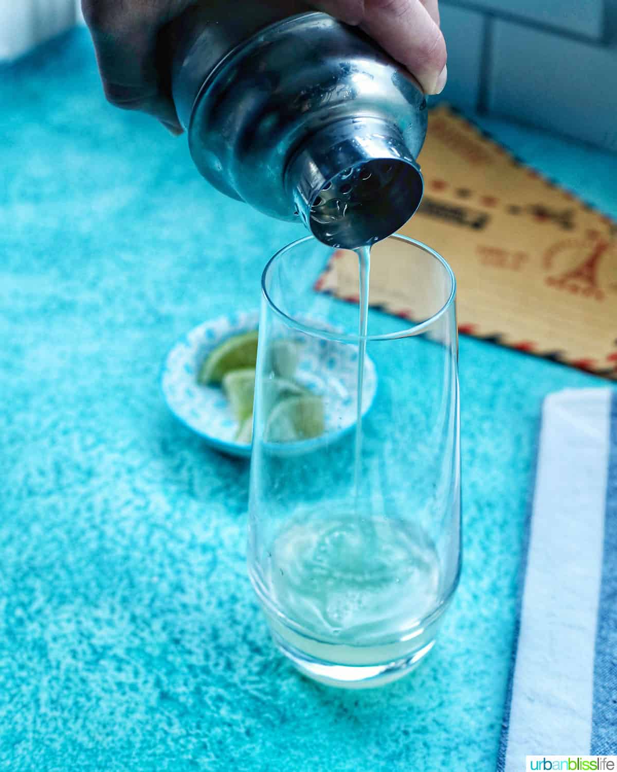 straining booze into airmail cocktail