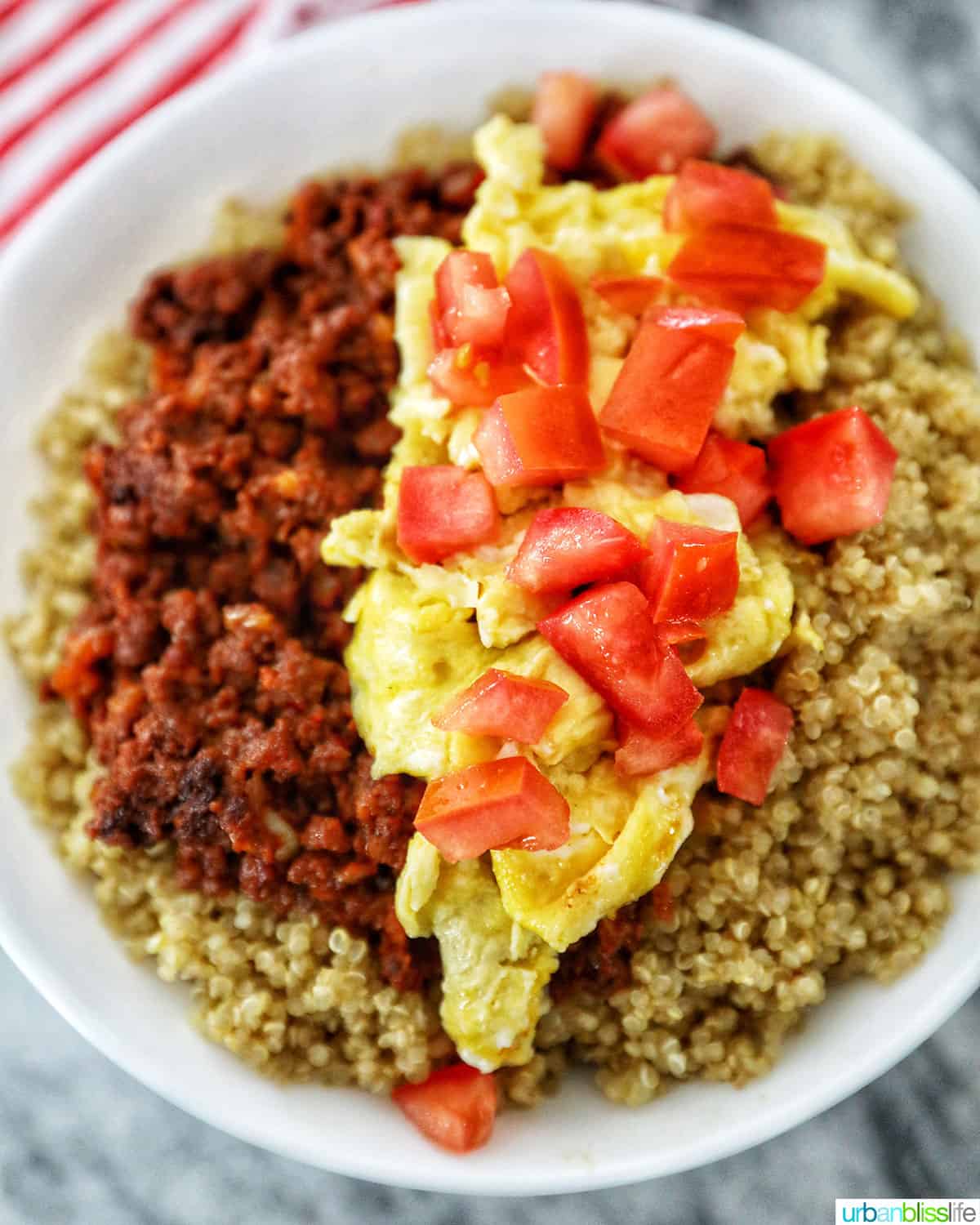 chorizo breakfast bowl topped with tomatoes