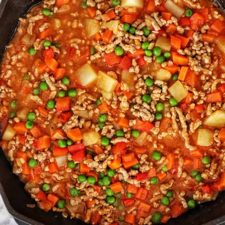 ground pork menudo in a cast iron skillet