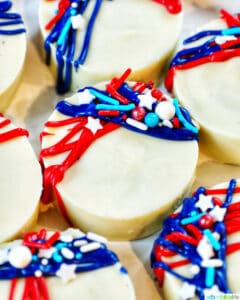 several red, white, and blue chocolate covered 4th of July Oreos with star sprinkles.