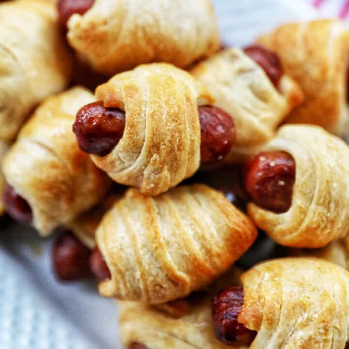 air fryer pigs in a blanket on white platter.