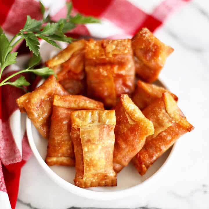 air fryer pizza rolls in a white bowl.