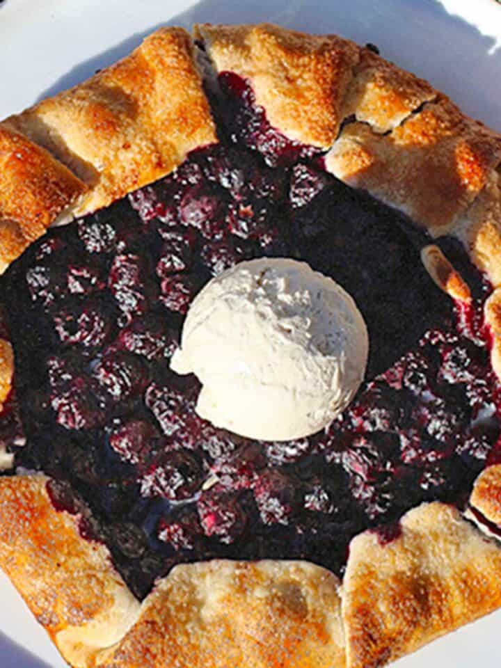 blueberry galette with a scoop of vanilla ice cream on top.