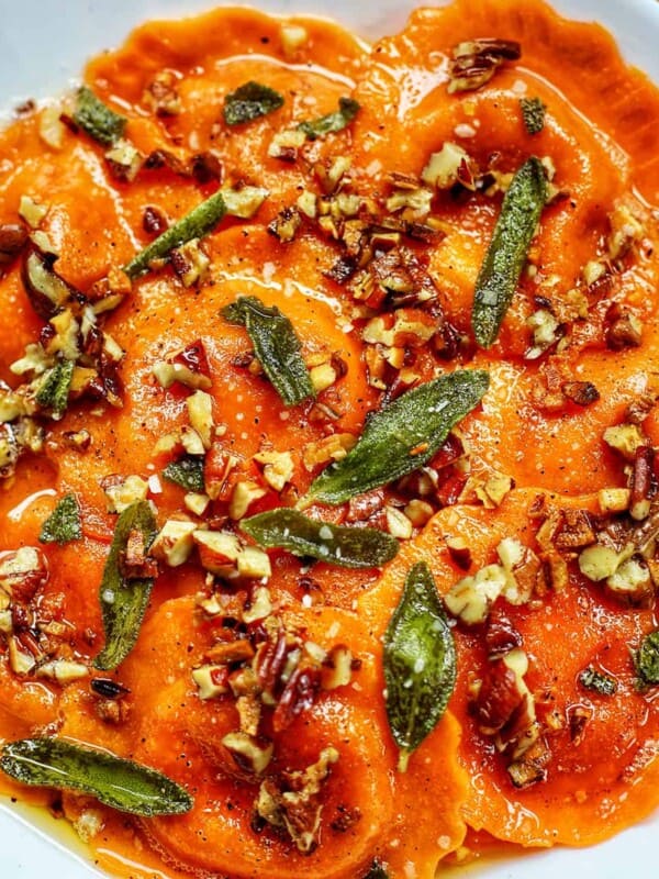 butternut squash ravioli with brown butter sage sauce and herbs.
