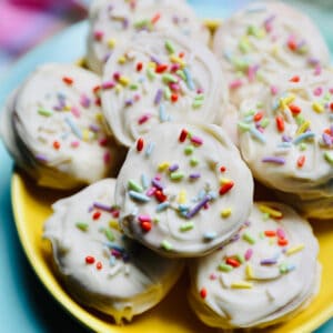 white chocolate covered peanut butter cracker cookies on a yellow plate.