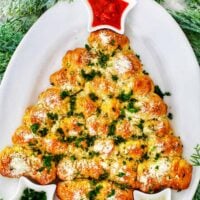 christmas tree pull-apart bread with marinara sauce and herbs.