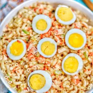 filipino macaroni salad with hard boiled egg halves in bowl.