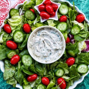 Christmas wreath salad with lettuce, cucumbers, and tomatoes.