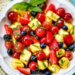 easy fruit salad with strawberries, blueberries, grapes, and pineapple.