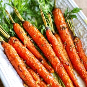 garlic rosemary glazed carrots on a platter.