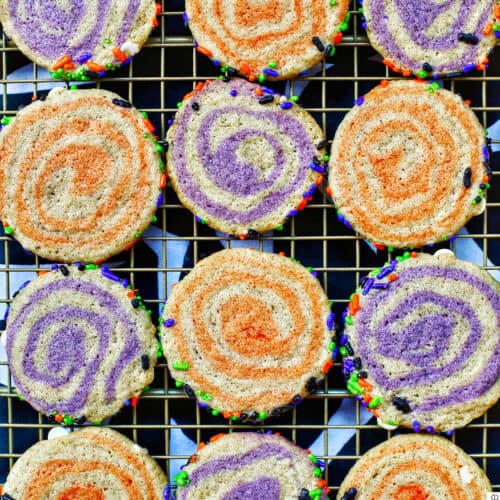 purple and orange Halloween pinwheel cookies on cooling rack.