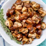 mushroom marsala in a bowl with herbs.