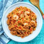 seafood jambalaya with shrimp and rice in a white bowl.