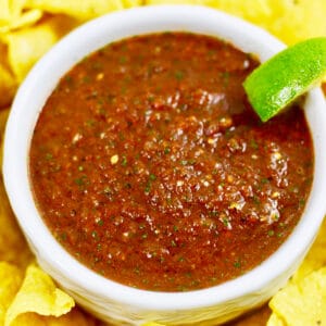 homemade restaurant-style salsa in a bowl with lime.