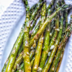 roasted garlic lemon asparagus on a white platter.